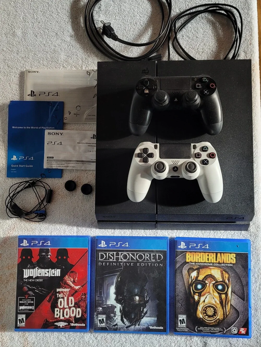 Sony PS4 Console with Black and White DualShock Controllers and Three Games
